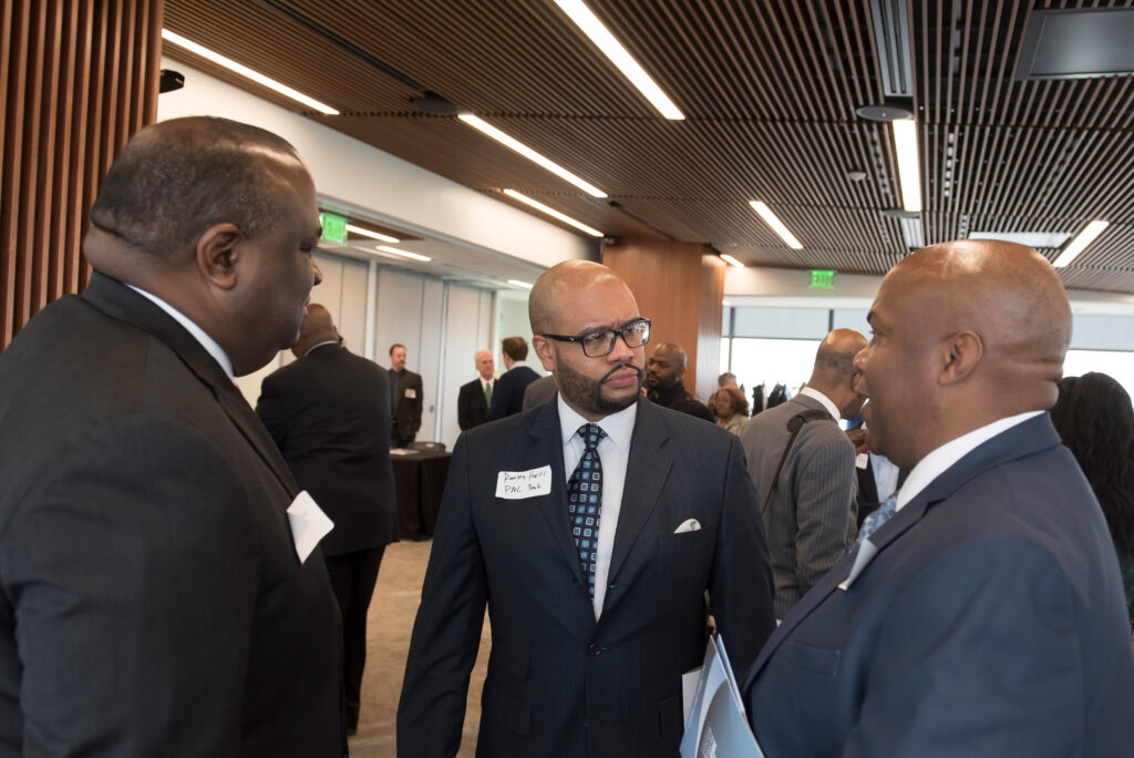 Ramsey Harris of PNC Bank (center) talks with attendees.